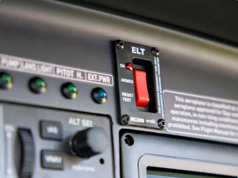 Cockpit ELT control panel with arm and test switches for the emergency locator transmitter.