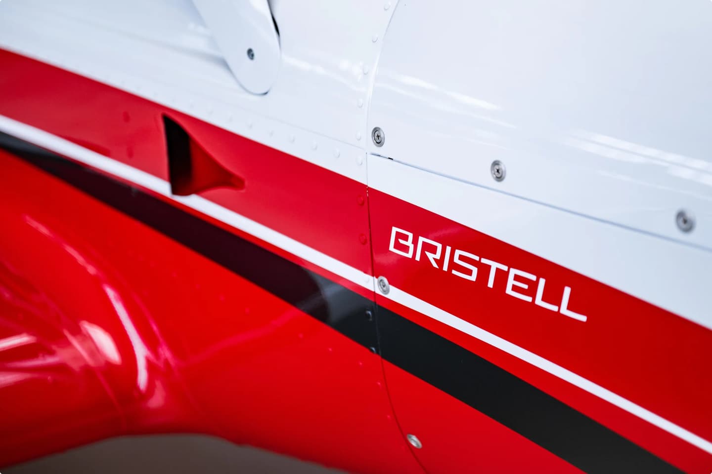Close-up of the red and white Bristell livery on an aircraft fuselage