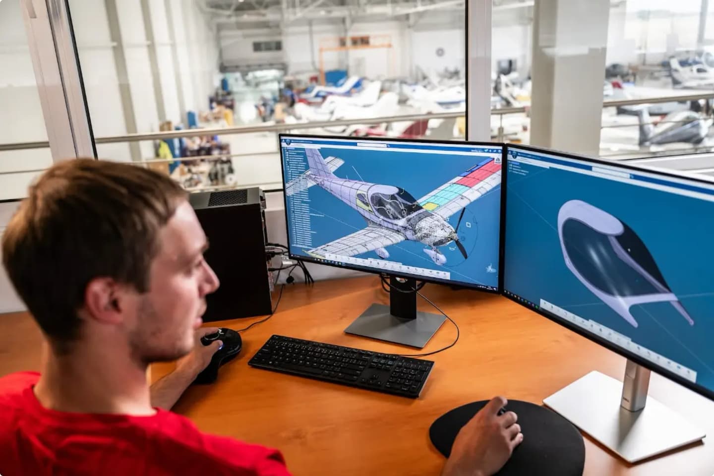 Bristell engineer reviewing a 3D aircraft model on dual monitors in the design office